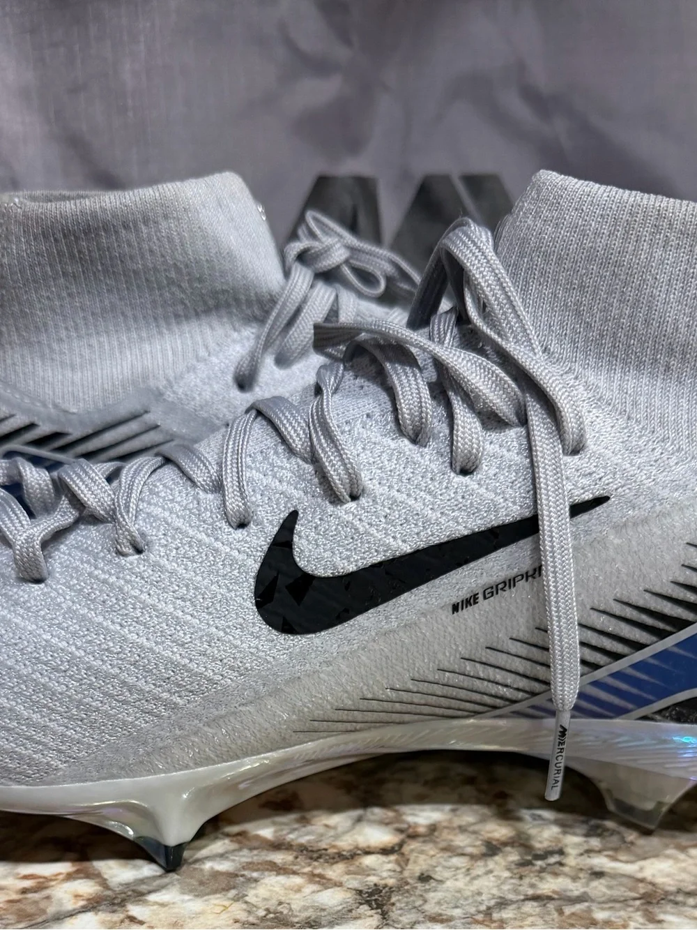 Nike Men’s Light Gray High-Top Soccer Cleats with Black Swoosh